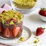 Dubai-style chocolate strawberry dessert served in a clear glass with pistachio crumble